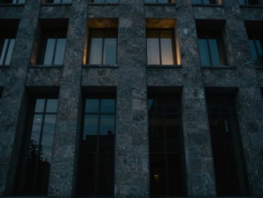 Architectural structure of stone and glass, with subtle gold backlighting, cinematic wide-angle, dark cinematic photography, 35mm
