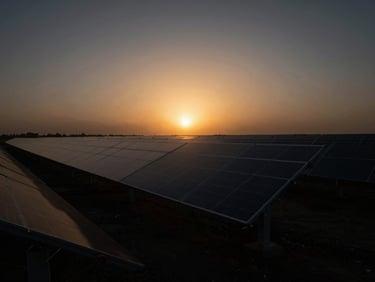 Wide shot of a futuristic solar farm at sunset, dramatic chiaroscuro, subtle gold ambient glow, anamorphic lens, 35mm