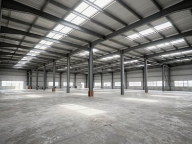 Spacious industrial warehouse interior with high ceilings, clean concrete floors, steel columns, natural light from skylights, realistic architectural perspective.
