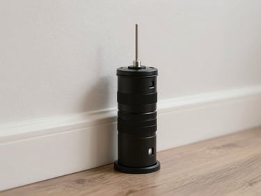 A tamper-proof bait station placed discreetly along a clean wall baseboard, professional pest control setup