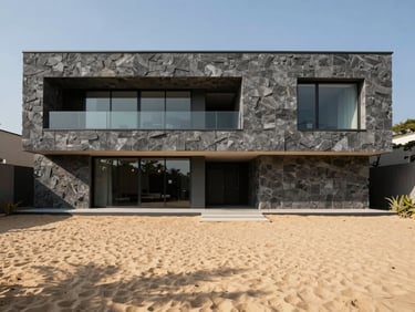 modern architectural photography, sharp natural sunlight, deep shadows, warm sand and charcoal tones, wide-angle lens, 35mm, luxury minimalist villa facade with natural stone walls