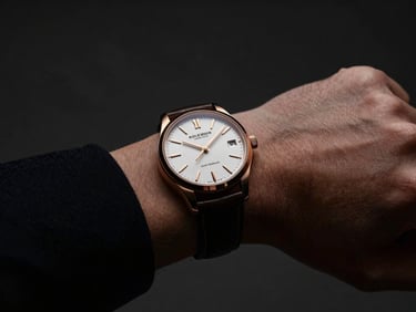 A close-up of a high-end luxury watch on a businessman's wrist, dark charcoal background, dramatic side lighting, 35mm photography