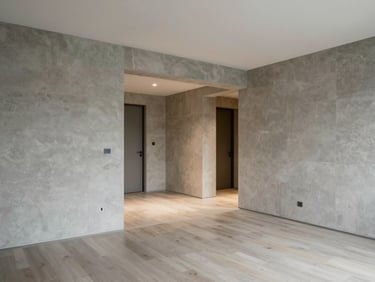 Clean wide-angle interior of a modern residential apartment showing functional layout and neutral stone-gray walls.