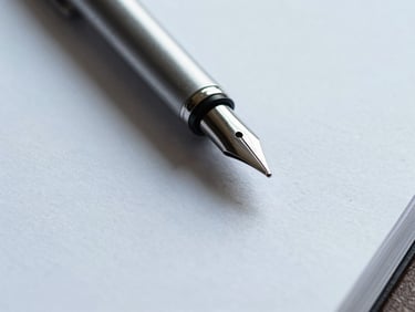 Extreme macro close-up of high-quality physical stationery, a heavy textured paper document with a clean steel pen resting on it, soft shadows, cool daylight.