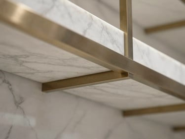 Macro detail of polished white marble and brushed steel structural elements inside a luxury retail space in Riyadh.