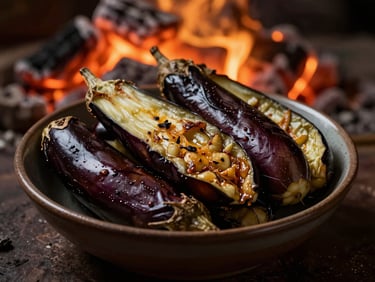 Fresh babagannuş in a small bowl, smoky eggplant texture visible, with a warm, low-key light source, 50mm