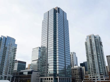 Wide-angle architectural shot of Vancouver downtown glass skyscrapers under bright overcast sky, clean corporate aesthetic, cool blue tones, 35mm lens