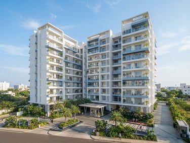 Bright architectural photography of a premium apartment exterior in Kakinada, clear coastal daylight, crisp white and soft blue tones, wide-angle lens.