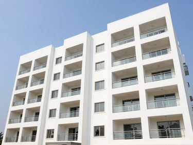Bright architectural exterior of Subha Gruha premium apartments in Kakinada, showing modern balconies, clean paint finishes, and clear daylight framing