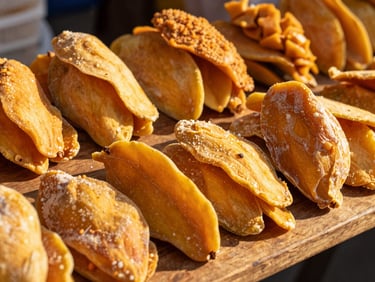 Vibrant display of premium dried mango sheets and purees on a wooden table at an open-air market, warm golden hour sunlight, rich mango tones