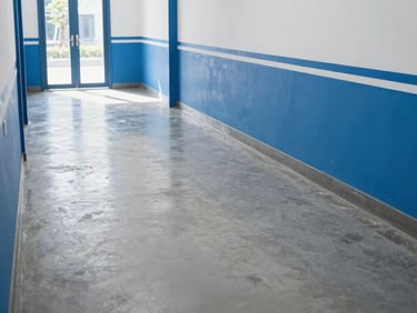 Clean empty hallway after professional clearance, bright daylight reflecting on polished concrete floor