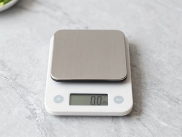 digital kitchen scale with fresh ingredients on a light gray marble countertop, bright natural daylight, sharp focus, 35mm