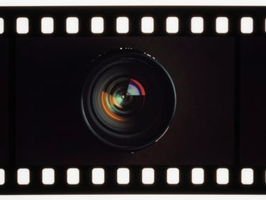 Macro close-up of the same 35mm film frame, perfectly restored, rich deep shadows, vibrant chromatic accuracy, crisp organic grain, anamorphic cinematic look