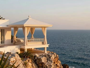 Luxury resort pavilion perched on a dramatic coastal cliff in Vietnam, overlooking a deep blue bay at sunset, warm golden lighting, 35mm.