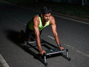 Indian athlete pushing a sled during high-intensity conditioning, sweat, neon reflections, dynamic angle, gritty athletic photography