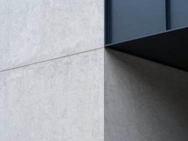Abstract structural shadows cast on a light gray concrete wall, clean geometric lines, minimalist corporate aesthetic.