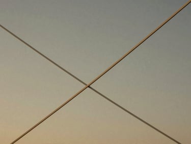Abstract representation of financial growth, elegant lines intersecting, soft golden light, minimalist, muted tones, medium-format film