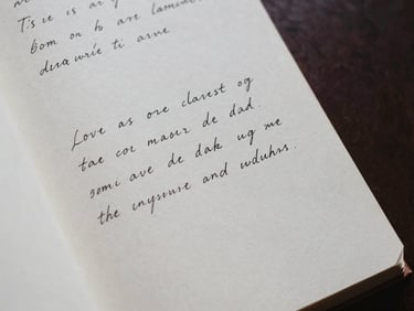An open book showing handwritten notes in the margins, textured cream paper, soft shadows.