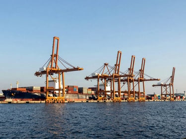 Wide environmental shot of a modern deep-water shipping port with cargo cranes under crisp natural daylight, editorial business photography