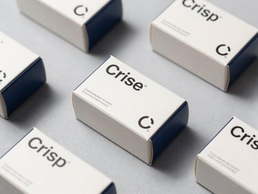 Crisp flat-lay of modern pharmaceutical packaging boxes on a clean light grey surface, sharp technical typography, minimalist design, high-contrast side lighting
