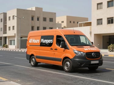 Wide shot of an orange All Hours Plumbers service van parked on a sunny Deira street, high-contrast daylight, recognizable Dubai low-rise concrete buildings in the background, sharp focus.