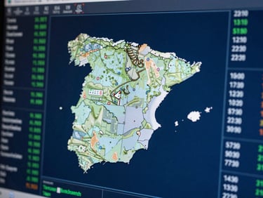 Macro shot of a high-contrast digital screen displaying structured data maps of Spain, cool blue tones, selective focus.