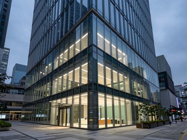 Wide-angle architectural view of a modern Hong Kong office interior, clean geometric lines, glass walls reflecting high-key corporate lighting.