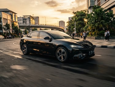Low-angle heroic tracking shot of a sleek black BYD Seal driving through the modern streets of Bandung at golden hour, sharp metallic reflections, professional commercial style, 35mm.