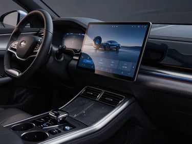 Macro shot of the modern center console and rotating touchscreen dashboard of a BYD car, dramatic studio lighting with high-contrast reflections, sharp metallic details.