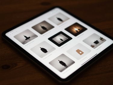 A close-up, high-contrast shot of a digital tablet displaying a grid of minimalist video thumbnail layouts, warm ambient lighting casting soft shadows across a dark wooden desk, 35mm