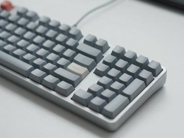 Minimalist product photography of a clean desktop setup with a sleek mechanical keyboard, soft overcast daylight, cool desaturated tones, sharp focus, macro details, high-end tech aesthetic.