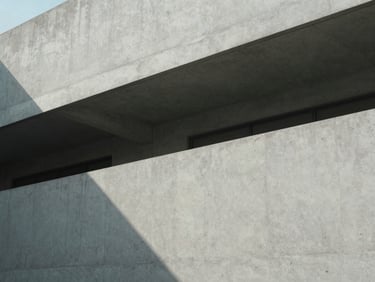 Minimalist architectural lines of a concrete building casting sharp geometric shadows under diffused daylight, 35mm photography