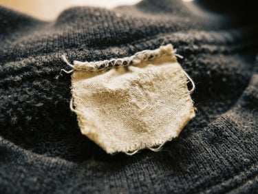 Close-up snapshot of a vintage clothing tag from the late 90s, slightly faded fabric texture, natural light, nostalgic tone