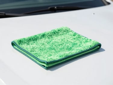 Microfiber cloth wiping a clean car dashboard, bright daytime lighting, crisp focus