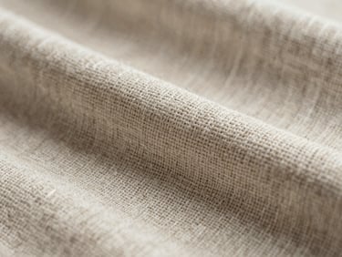 Macro close-up of premium woven linen fabric texture, showing the organic flax threads under soft natural light, muted earth tones.