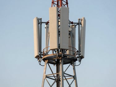 Macro shot of a high-altitude infrastructure project in Equatorial Guinea, clean modern telecom towers against a crisp daylight sky, representing strategic elevation.
