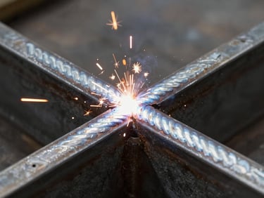 Close-up of a perfectly uniform, clean weld bead on heavy structural steel, bright arc welding sparks illuminating the dark metal surface, high-contrast.