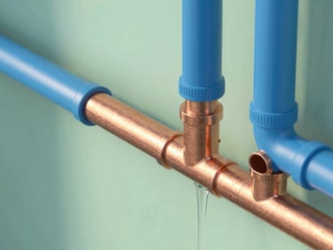 Cross-section diagram of clean residential plumbing pipes, showing water flowing smoothly through copper and PVC sections, crisp technical illustration with blue accents.