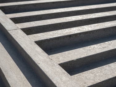 Macro crop of structured architectural lines and concrete surfaces, sharp shadows, bright direct daylight, emphasizing precision and structure