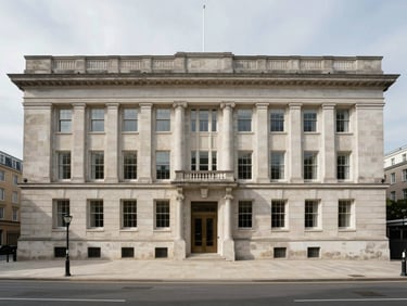 Symmetrical wide shot of classic limestone corporate architecture, clean lines, overcast daylight, low contrast shadows, presenting absolute permanence.
