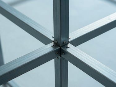 Abstract macro photograph of steel and glass structural joints, sharp dramatic lighting, sterile architectural studio setting, blueprint-cyan tint
