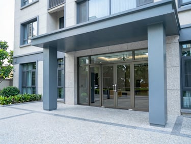 Clean condominium entrance, polished granite floors, modern architectural lines, crisp daylight