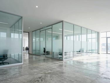 Bright modern office lobby with polished concrete floor, clean glass partitions, natural light