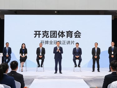 Dynamic wide shot of a corporate event, focused on speakers on stage, branding visible, crisp lighting, sharp 35mm lens