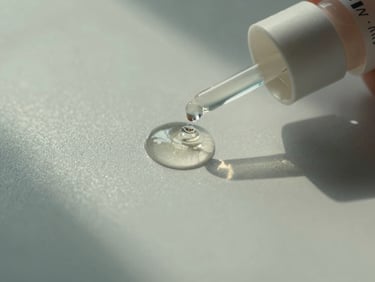 Macro shot of liquid retinol droplets on a clean glass surface, soft shadows, north-facing natural daylight