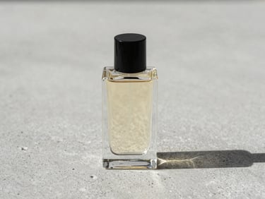 Minimalist still life of a luxury perfume bottle on a textured concrete surface, soft diffused side daylight