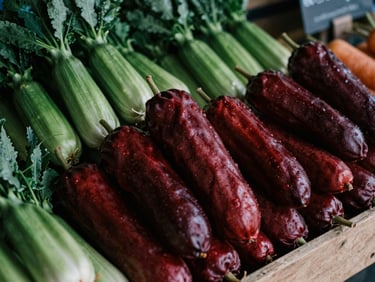 Rustic market stall with fresh produce, natural light, deep crimson and forest green tones, rich textures, 35mm film