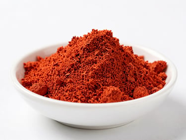 Vibrant red tomato powder in a clean white bowl on a sterile surface, bright studio light, macro depth of field