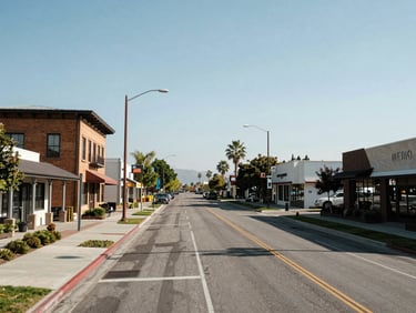 Wide daytime streetscape of Rancho Cordova's commercial and residential corridor, newer mixed-use buildings along a wide boulevard, clear sky, natural daylight exposure