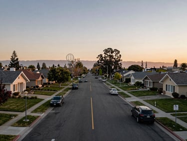 Environmental wide shot comparing a Bay Area suburb streetscape at dusk with a Sacramento-area cul-de-sac at the same hour, side-by-side architectural contrast, natural fading light